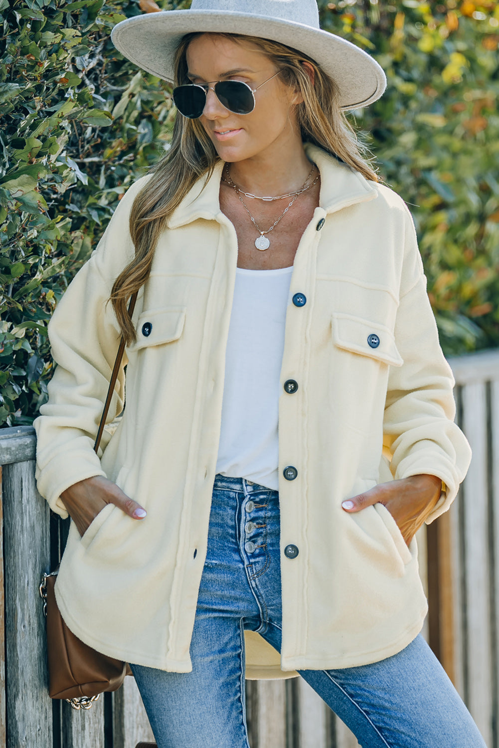 Cream fleece shirt jacket with patch pockets and button front.