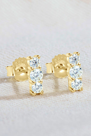 Gold triple stone bar stud earrings with clear cubic zirconia accents.