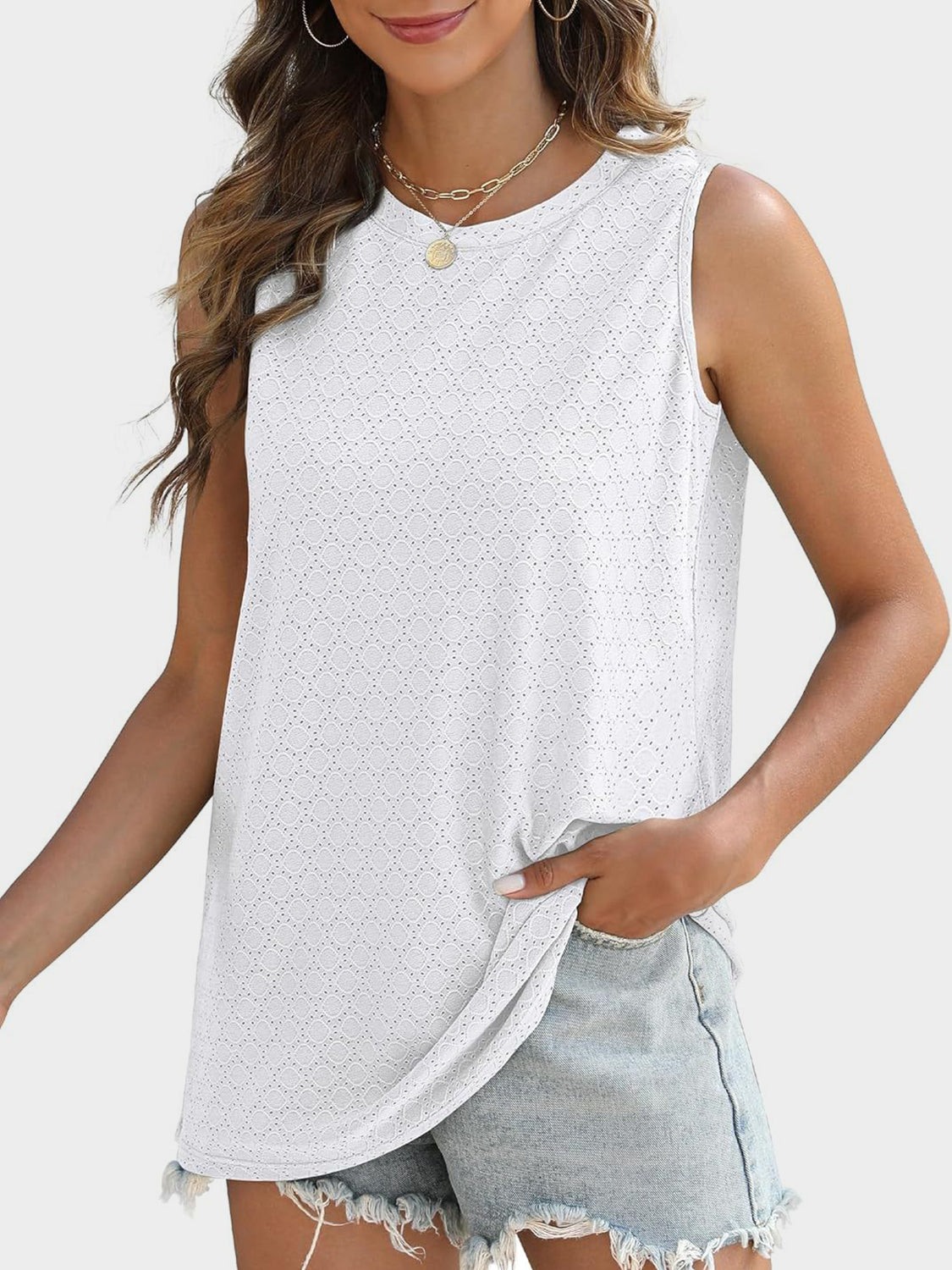 White textured sleeveless shell top with eyelet pattern and crew neck