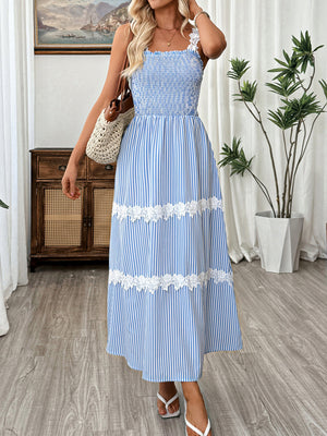 Blue striped midi dress with smocked bodice and lace trim, square neckline, spaghetti straps.