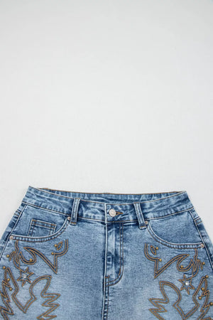 Blue denim shorts with western-inspired embroidery and stud details.