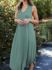 Light green tank midi dress with asymmetrical hemline and V-neckline.