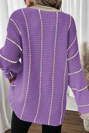 Lavender knit oversized V-neck dress with vertical stripe detail and waffle texture.