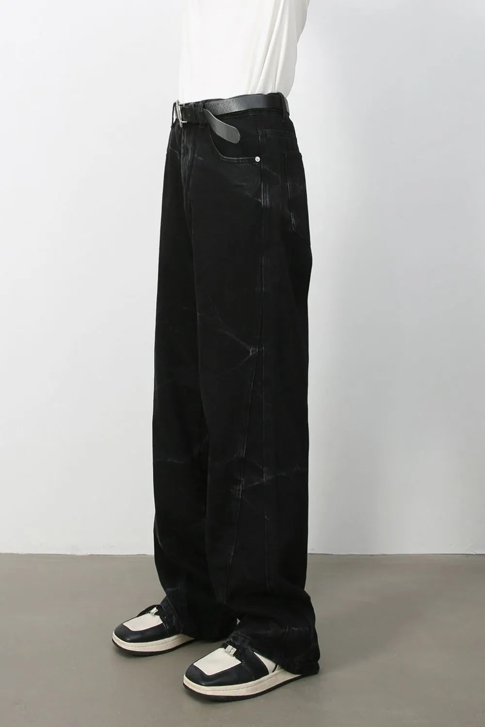 Faded black wide-leg denim jeans with a relaxed fit and subtle distressed details.