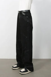 Faded black wide-leg denim jeans with a relaxed fit and subtle distressed details.