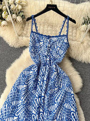 Blue and white lace-embroidered cami dress with tiered skirt and cutout details.