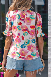 Vibrant floral print cotton blend shirt with ruched short sleeves and a ruffled neckline.