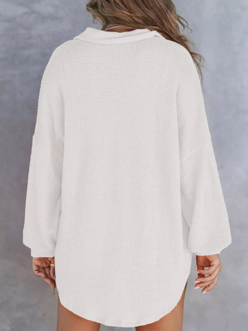 White waffle-knit henley tee with buttoned collar and long sleeves.
