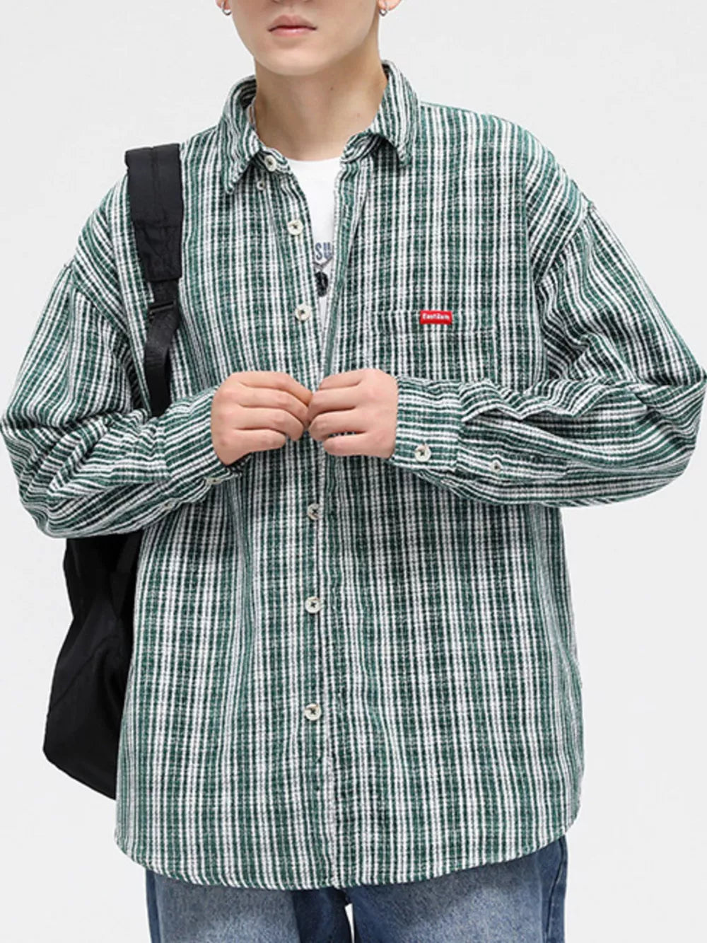 Men's dark green plaid button-up shirt with chest pocket and white stripes.