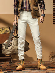Men's cream cotton denim trousers with zip detail and moto-style knee panels.