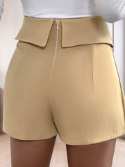 Tan collar-waist pleated skort shorts with a zip closure and a folded waistband detail.