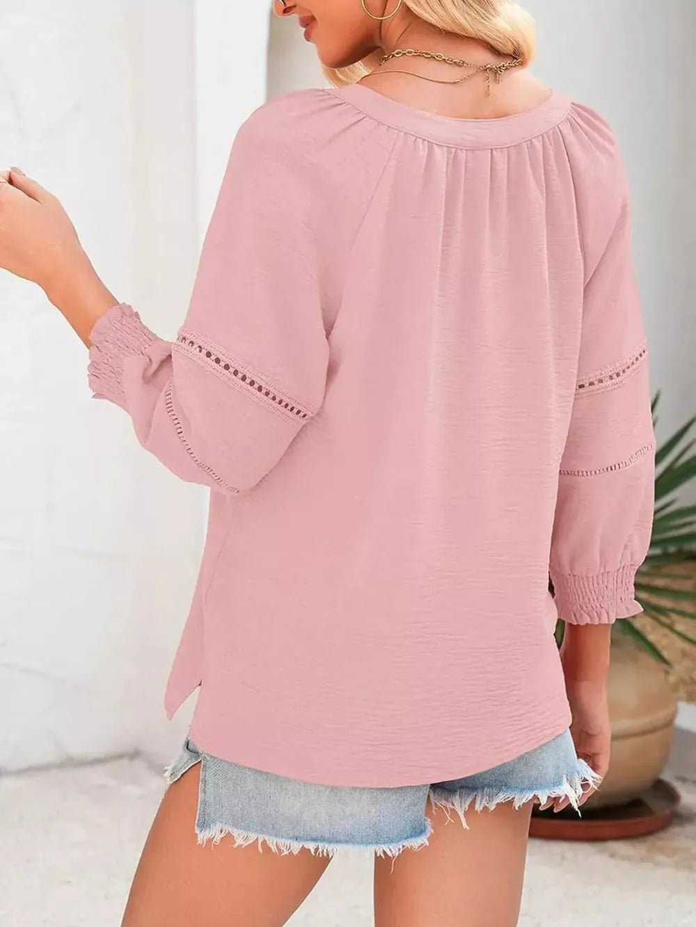Light pink polyester blouse with smocked cuffs and lace trim on sleeves.