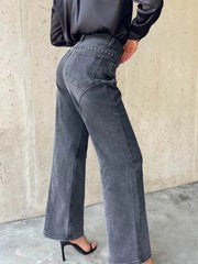 Dark gray studded high-waisted wide-leg jeans with button fly and flared hem.