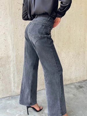 Dark gray studded high-waisted wide-leg jeans with button fly and flared hem.