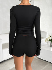 Black long sleeve Henley crop top and fitted shorts set.