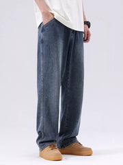 Men's blue vintage wash loose fit cotton jeans with pockets.