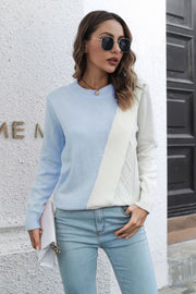 Diagonal knit colorblock sweater in light blue and white with diamond pattern detail.