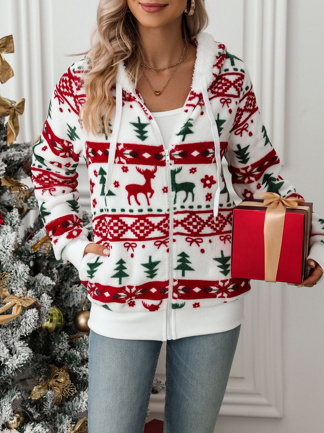 White fleece zip-up hoodie with festive Fair Isle pattern of reindeer and trees.