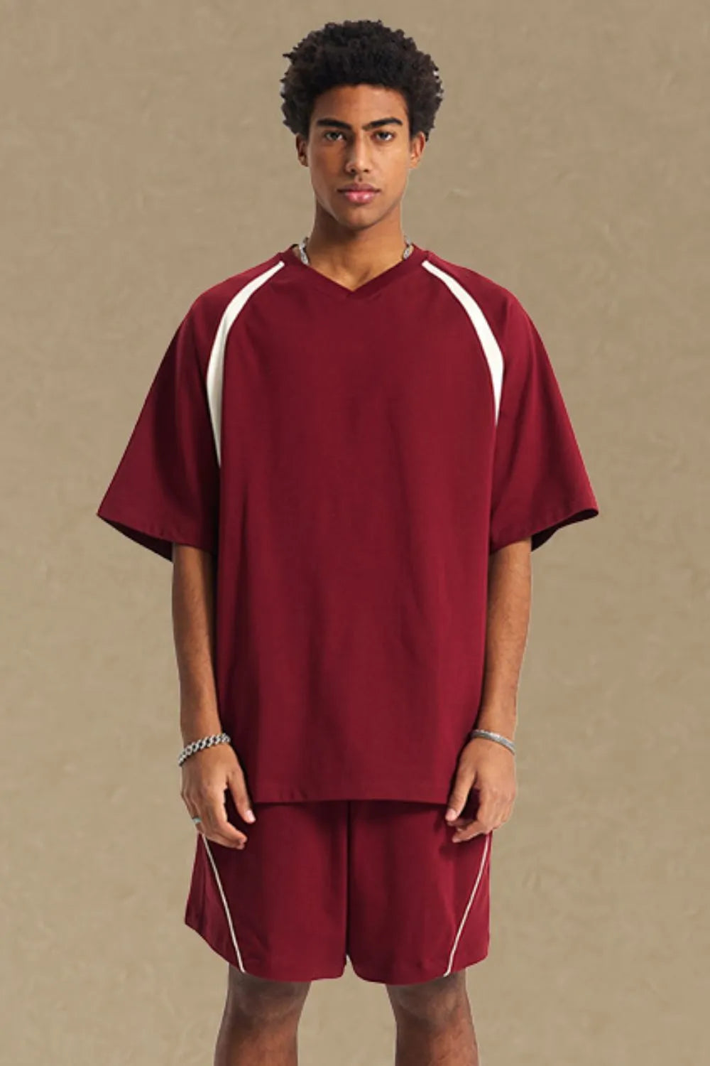 Burgundy V-neck raglan tee with white contrast sleeves and trim.