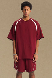 Burgundy V-neck raglan tee with white contrast sleeves and trim.