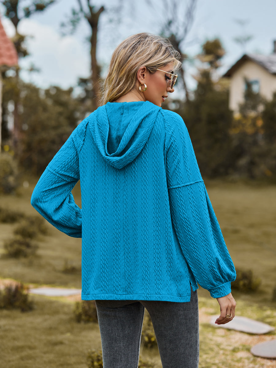 Sky blue textured knit hoodie with balloon sleeves and cable detail.