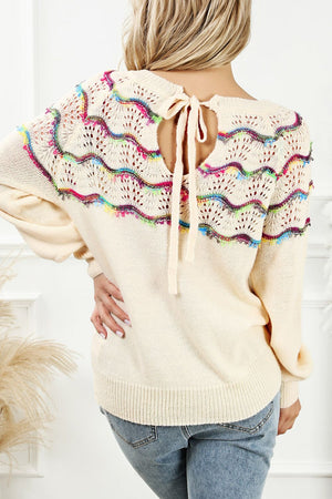 Cream knit sweater with rainbow scallop detail and back tie closure