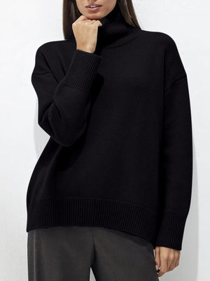 Black acrylic turtleneck sweater with sculptural sleeves and ribbed cuffs and hem.