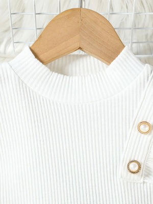 White ribbed mock neck top with decorative pearl buttons on sleeve