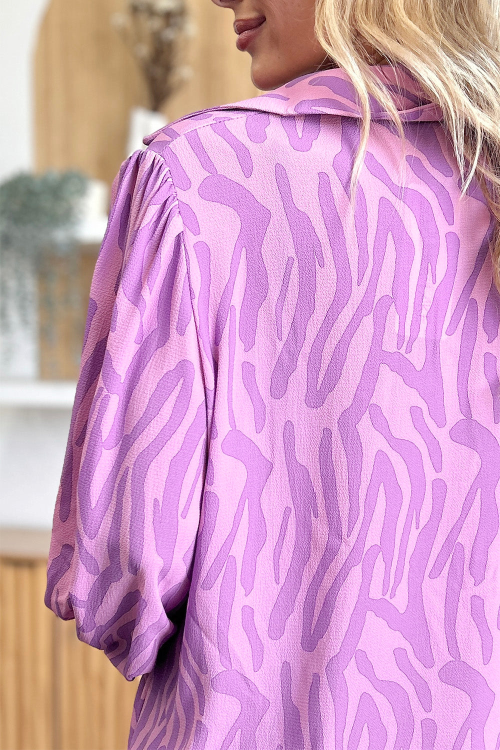 Lavender zebra print blouse with shirred cuffs and collar detail.
