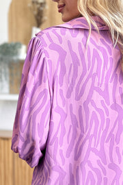 Lavender zebra print blouse with shirred cuffs and collar detail.