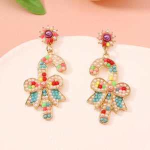 Festive candy cane bow earrings with colorful beads and pearl accents.