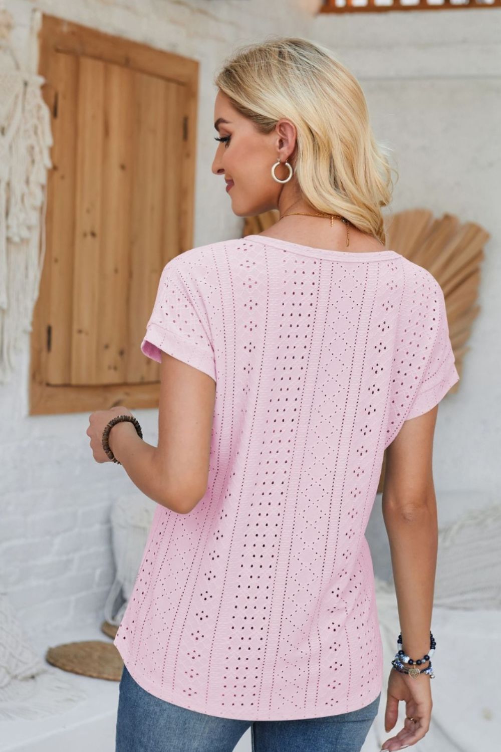 Blush pink perforated eyelet t-shirt with cuffed short sleeves and a relaxed fit.
