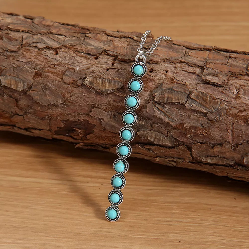 Timeless turquoise beaded pendant necklace with silver alloy chain.
