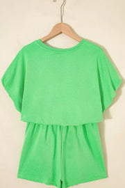 Green cotton two-piece outfit set with drawstring shorts and a layered top.