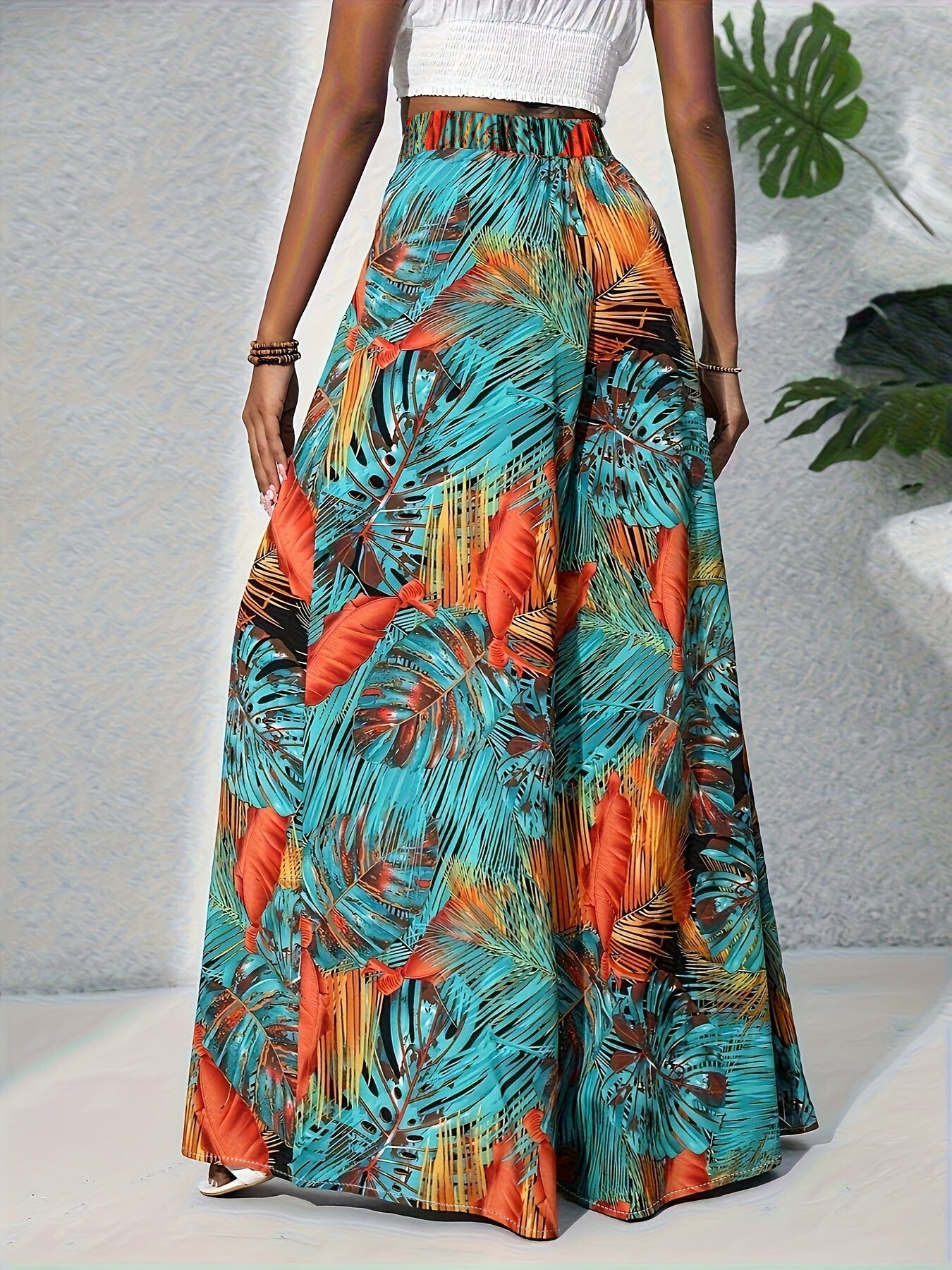 Tropical print wide leg pants with elastic waistband and flowy silhouette.