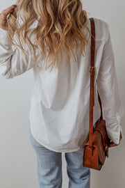 White cotton button-up shirt with eyelet ruffle detail, casual long sleeves.