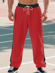 Men's bright red wide-leg sweatpants with black side stripe and drawstring.