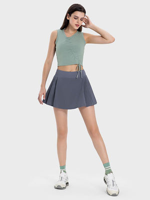 Pleated performance mini skirt in Dark Gray with a flared cut.
