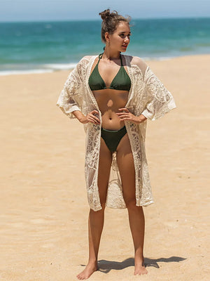 Apricot lace kimono cover-up with floral pattern and wide sleeves worn over a bikini.