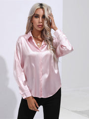 Blush pink satin tie-front blouse with buttoned front and collar.