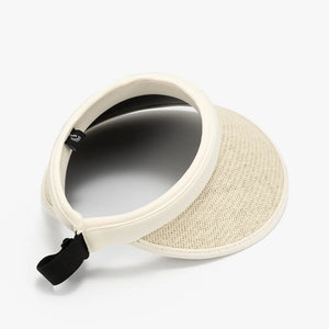 Woven brim sun visor in ivory with contrast trim and black adjustable strap.