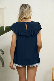 Dark blue blouse with ruffle yoke and short ruffle sleeves, keyhole back detail.