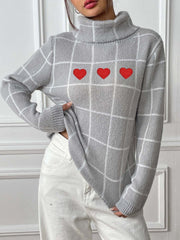 Light gray turtleneck sweater with white grid pattern and three red heart appliqués.