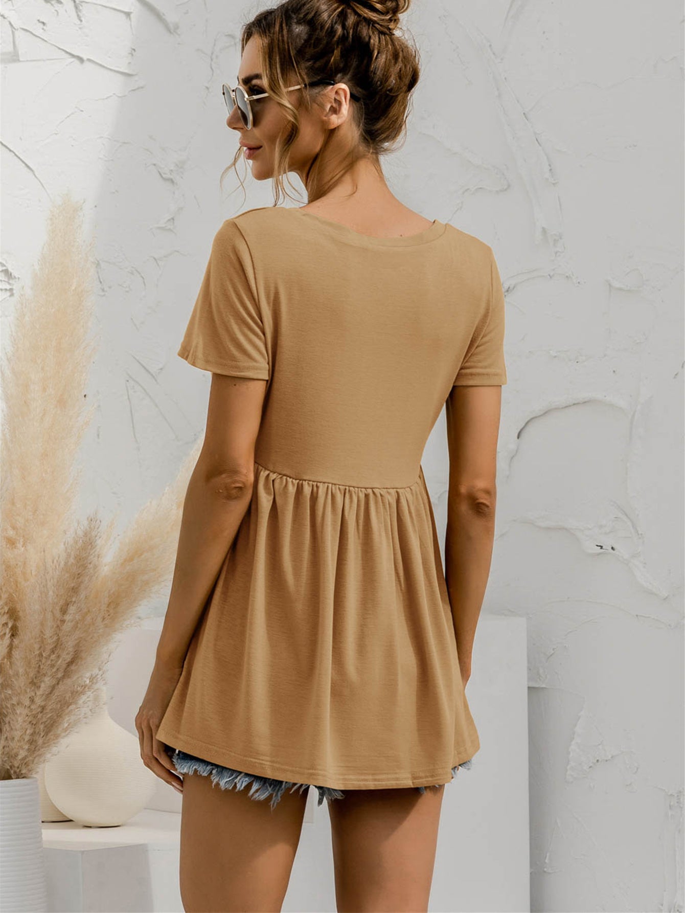 Khaki V-neck tee with short sleeves and a gathered waistline, peplum style