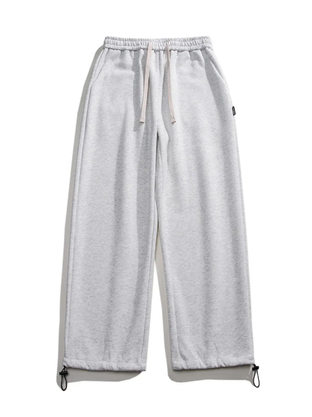Light gray cotton sweatpants with drawstring waist and adjustable ankle cuffs.