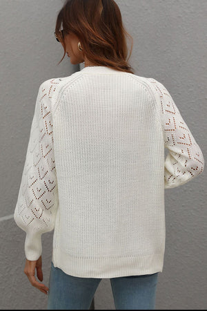 White diamond knit cardigan with openwork sleeves and ribbed cuffs.