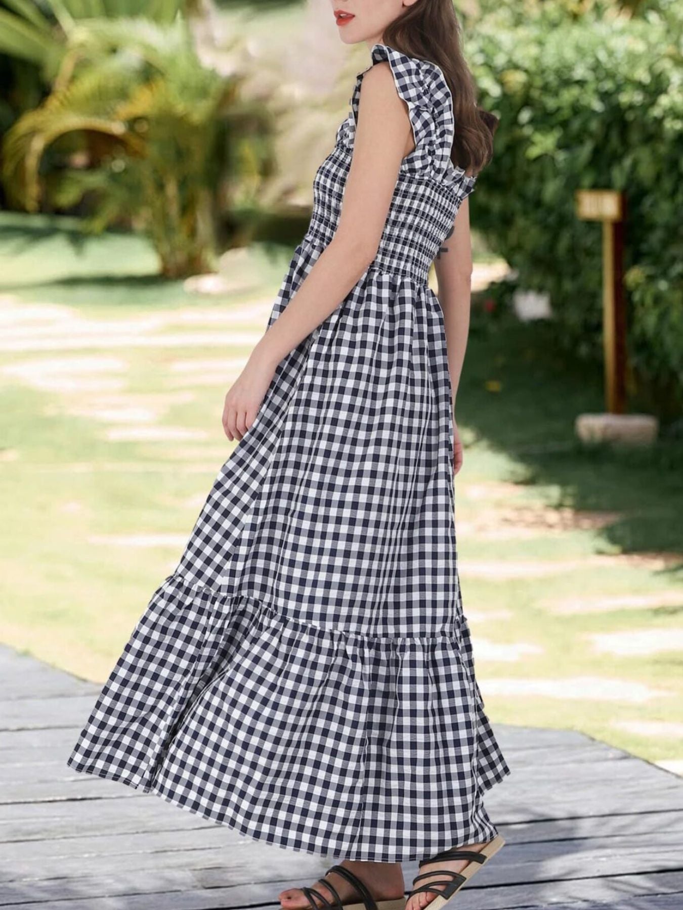 Black gingham midi dress with smocked bodice and ruffled sleeves.
