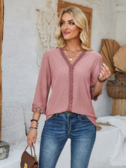 Dusty pink eyelet v-neck blouse with lace trim and 3/4 sleeves.
