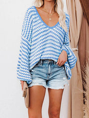 Geometric knit v-neck sweater in blue and white with bell sleeves.