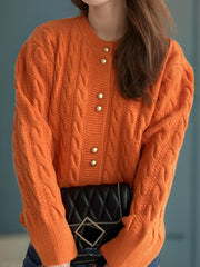 Orange cable knit cardigan with puff sleeves and gold buttons, acrylic material.